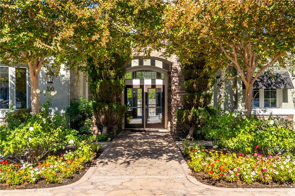 20000 Plum Canyon Road, Unit 1221 Saugus, CA 91350 - Photo 18 of 20 a front view of a house with a garden