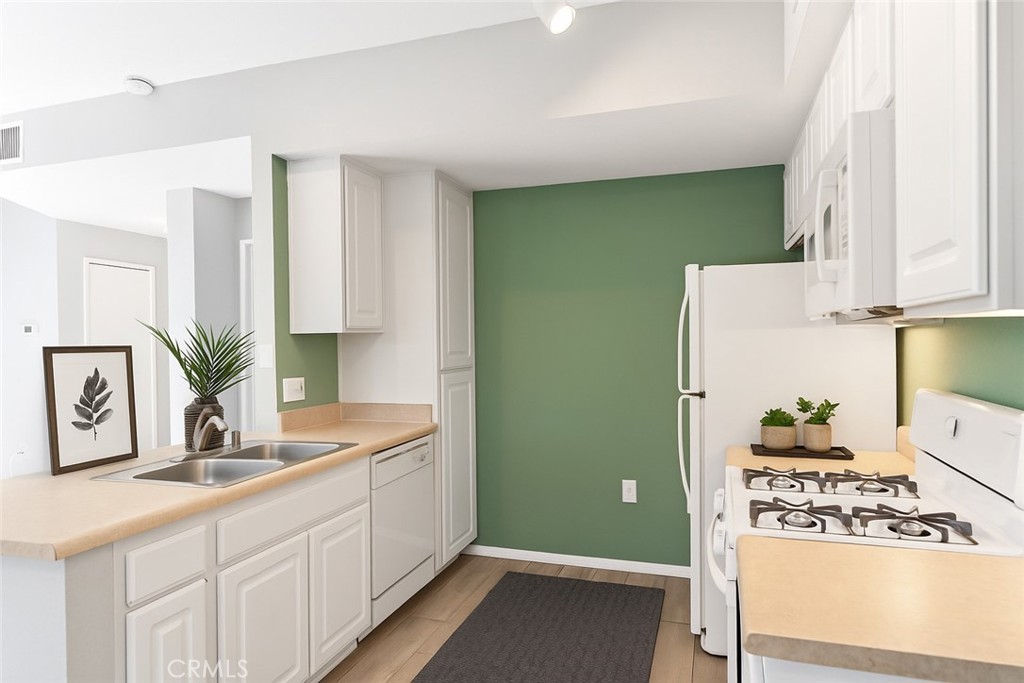 20000 Plum Canyon Road, Unit 1221 Saugus, CA 91350 - Photo 2 of 20 a kitchen with cabinets and window