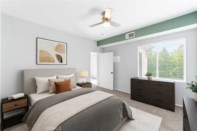 a bedroom with a large bed and a window