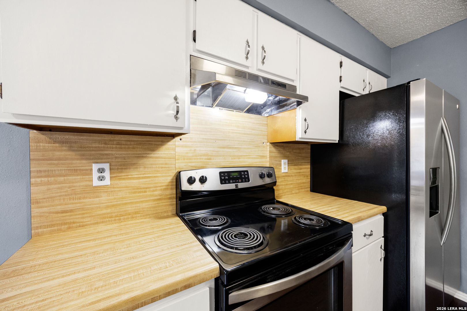 9334 Dover Ridge San Antonio, TX 78250 - Photo 15 of 42 a kitchen with a stove and a refrigerator