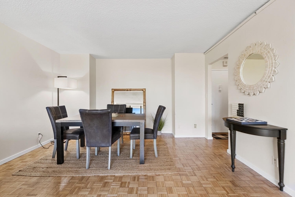 33 Pond Avenue, Unit 709 Brookline, MA 02445 - Photo 11 of 29 a view of a dining room with furniture
