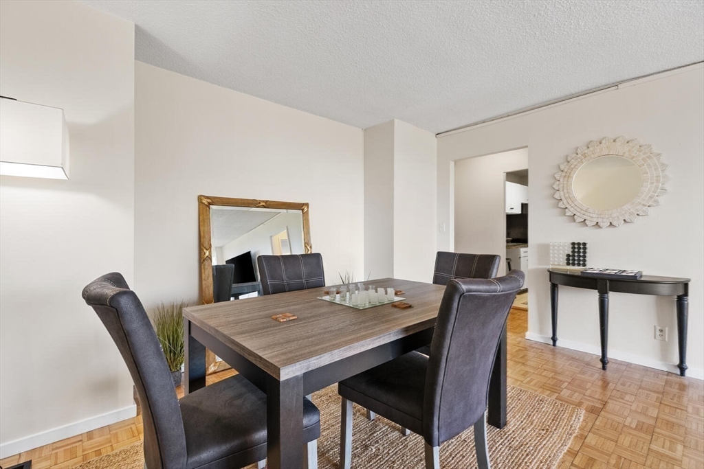 33 Pond Avenue, Unit 709 Brookline, MA 02445 - Photo 12 of 29 a view of a dining room with furniture