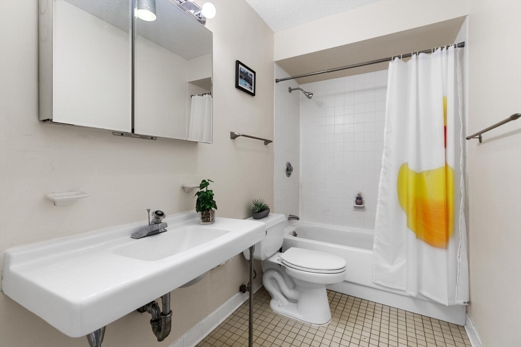 33 Pond Avenue, Unit 709 Brookline, MA 02445 - Photo 13 of 29 a bathroom with a sink toilet and shower