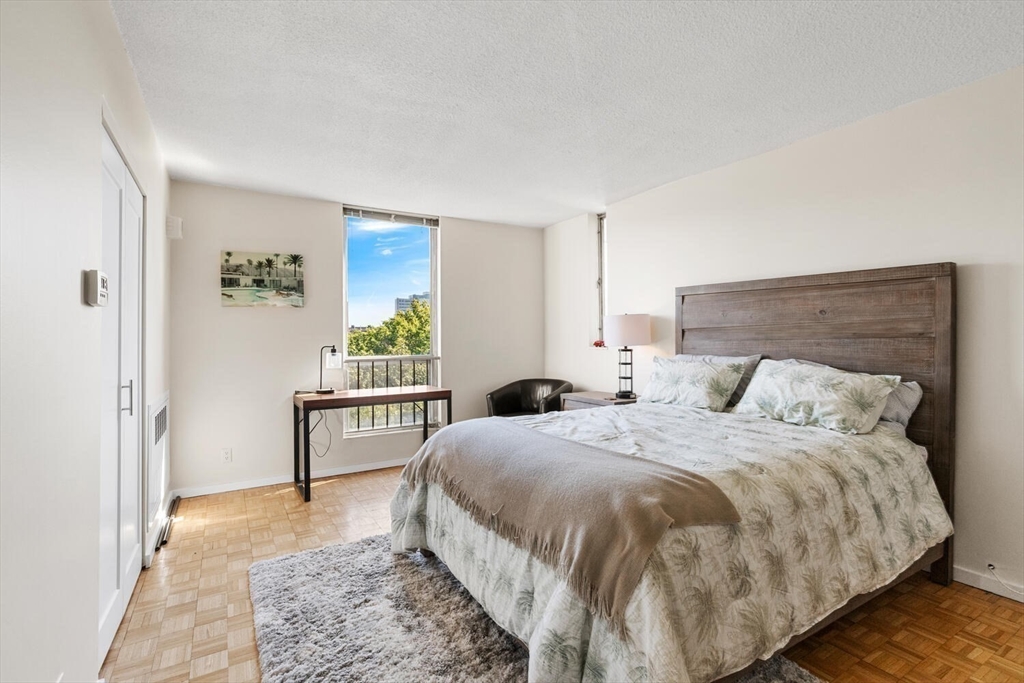 33 Pond Avenue, Unit 709 Brookline, MA 02445 - Photo 14 of 29 a bedroom with a bed and a window