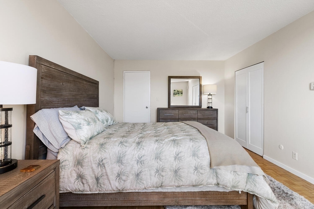 33 Pond Avenue, Unit 709 Brookline, MA 02445 - Photo 15 of 29 a living room with couch