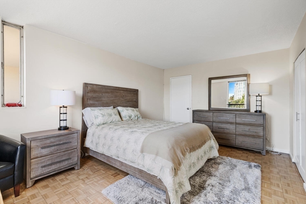 33 Pond Avenue, Unit 709 Brookline, MA 02445 - Photo 16 of 29 a bedroom with a bed and a dresser