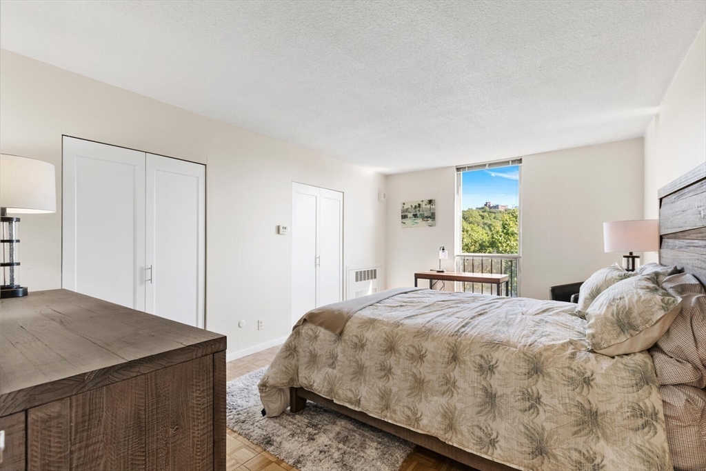 33 Pond Avenue, Unit 709 Brookline, MA 02445 - Photo 4 of 29 a bedroom with a bed and a window