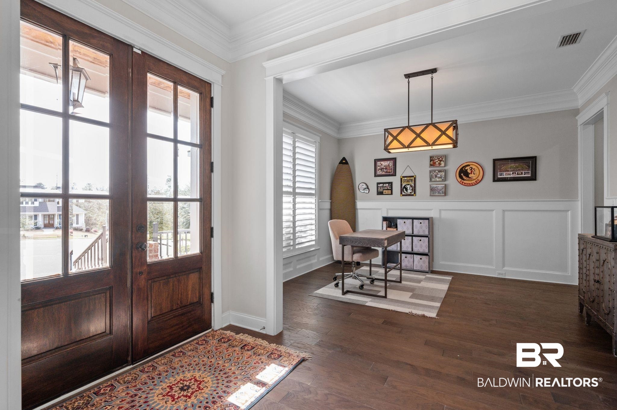 32194 Badger Court Daphne, AL 36527 - Photo 5 of 49 Entrance foyer featuring a decorative wall, dark wood-style floors, ornamental molding, and wainscoting