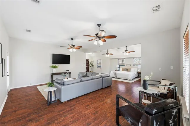 a living room with furniture a chandelier and a flat screen tv