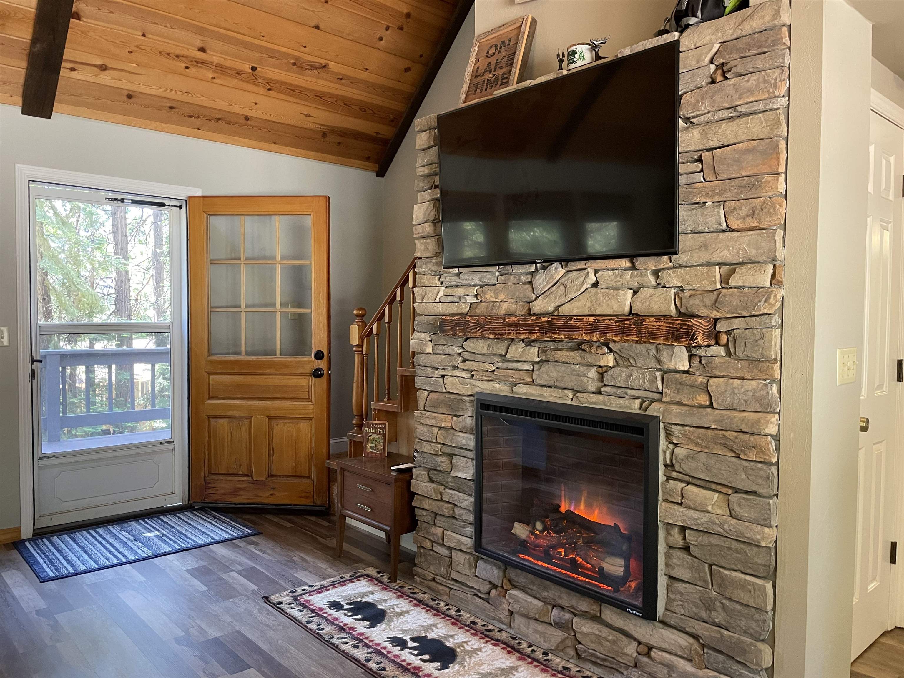 603 East Burnt Cedar Road Lake Almanor, CA 96137 - Photo 7 of 33 a living room with fireplace and a flat screen tv