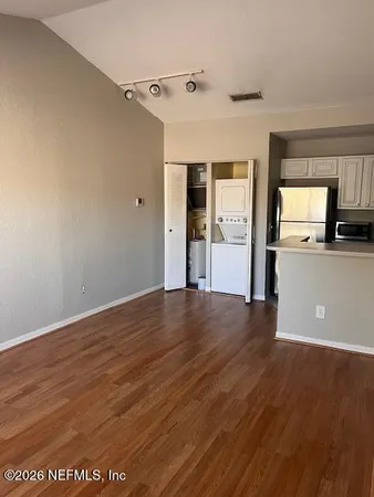 a view of a kitchen with wooden floor