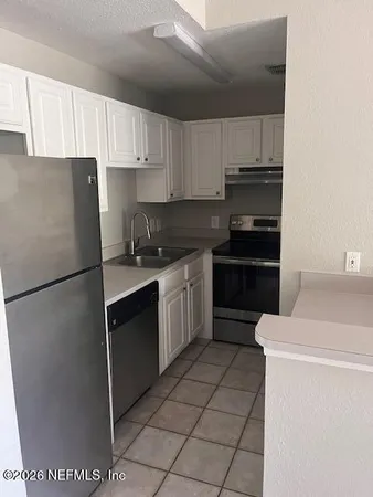 a kitchen with a sink a stove and refrigerator