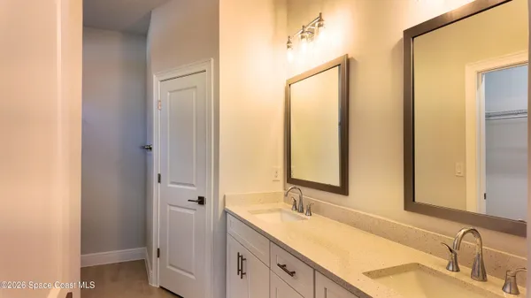 a bathroom with a double vanity sink and mirror