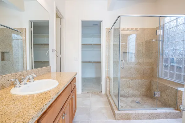 a bathroom with a shower sink and mirror