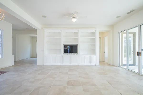 an empty room with a empty space and windows