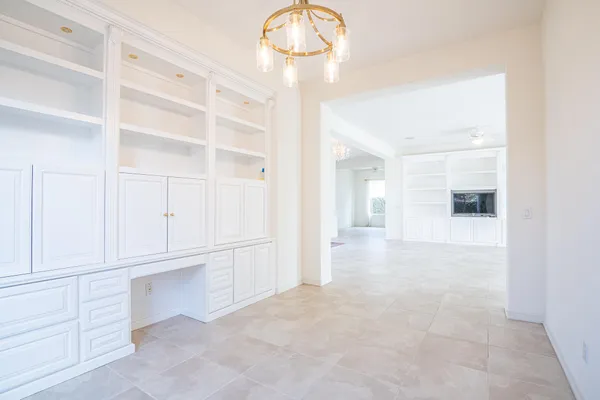 a view of empty room with cabinet and window