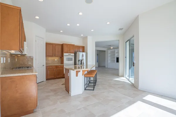 a view of a kitchen with refrigerator and furniture