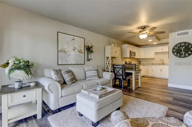 a living room with furniture and kitchen view