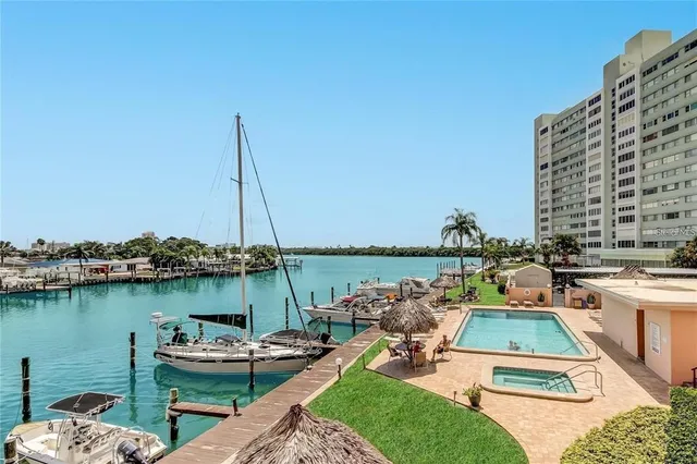 a view of a lake with chairs