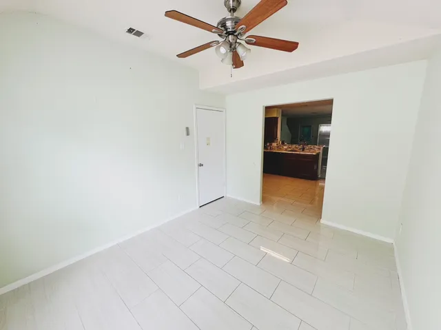 a view of a livingroom with a ceiling fan and a fan