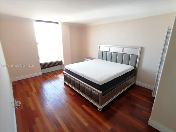 a bed sitting in a bedroom next to a window