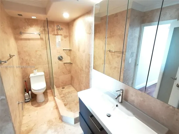 a bathroom with a bathtub shower sink and toilet