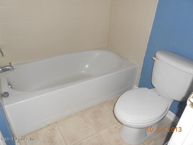 4689 Barnes Road South, Unit 3D Jacksonville, FL 32207 - Photo 8 of 10 a white toilet sitting next to a bath tub