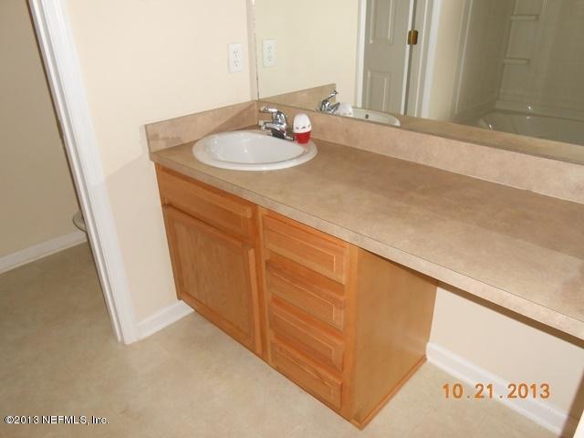 4689 Barnes Road South, Unit 3D Jacksonville, FL 32207 - Photo 10 of 10 a bathroom with a sink and a mirror