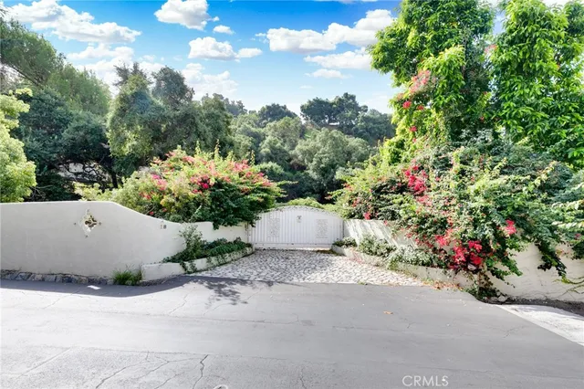 a flower garden with a bench in front of it