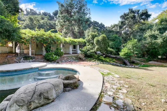 a swimming pool with outdoor seating and yard