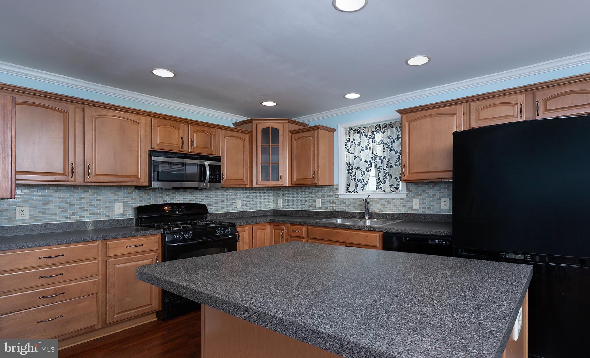 135 Mapleton Boulevard Harrisburg, PA 17112 - Photo 10 of 45 Modern kitchen with warm wood accents.