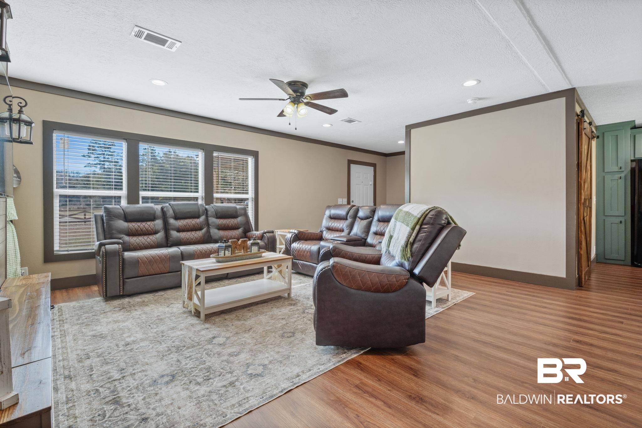 15080 Starlight Avenue Wilmer, AL 36587 - Photo 10 of 29 Living room with crown molding, hardwood / wood-style flooring, a textured ceiling, and ceiling fan