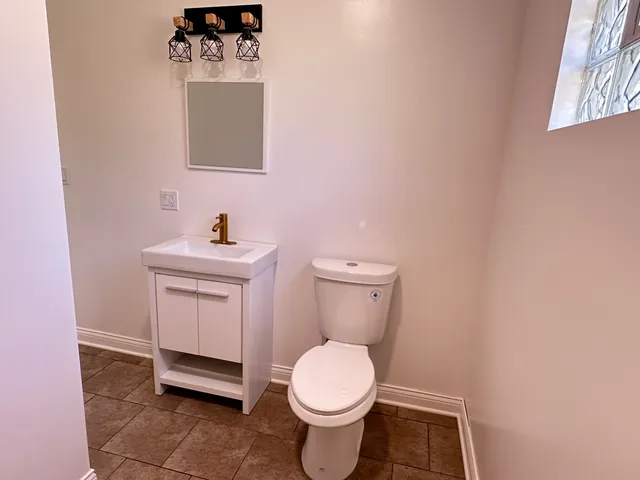 a white toilet sitting next to a bathroom sink