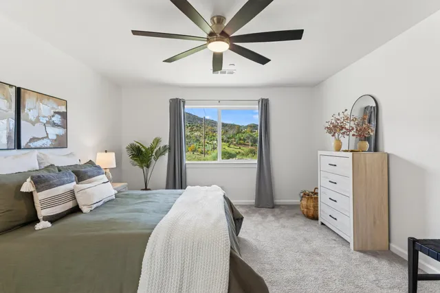 a spacious bedroom with a bed and a window