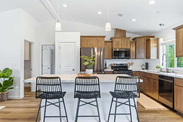 a view of a kitchen with dining table chairs and entryway
