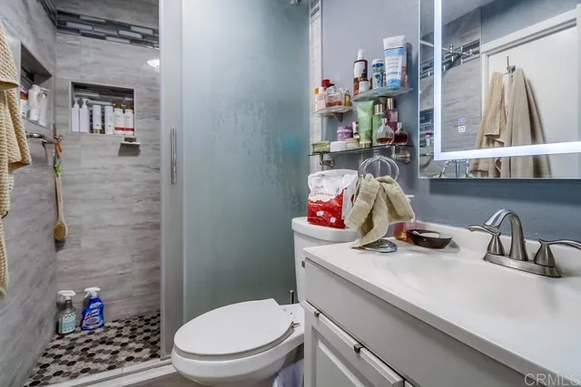 a bathroom with a sink toilet and shower