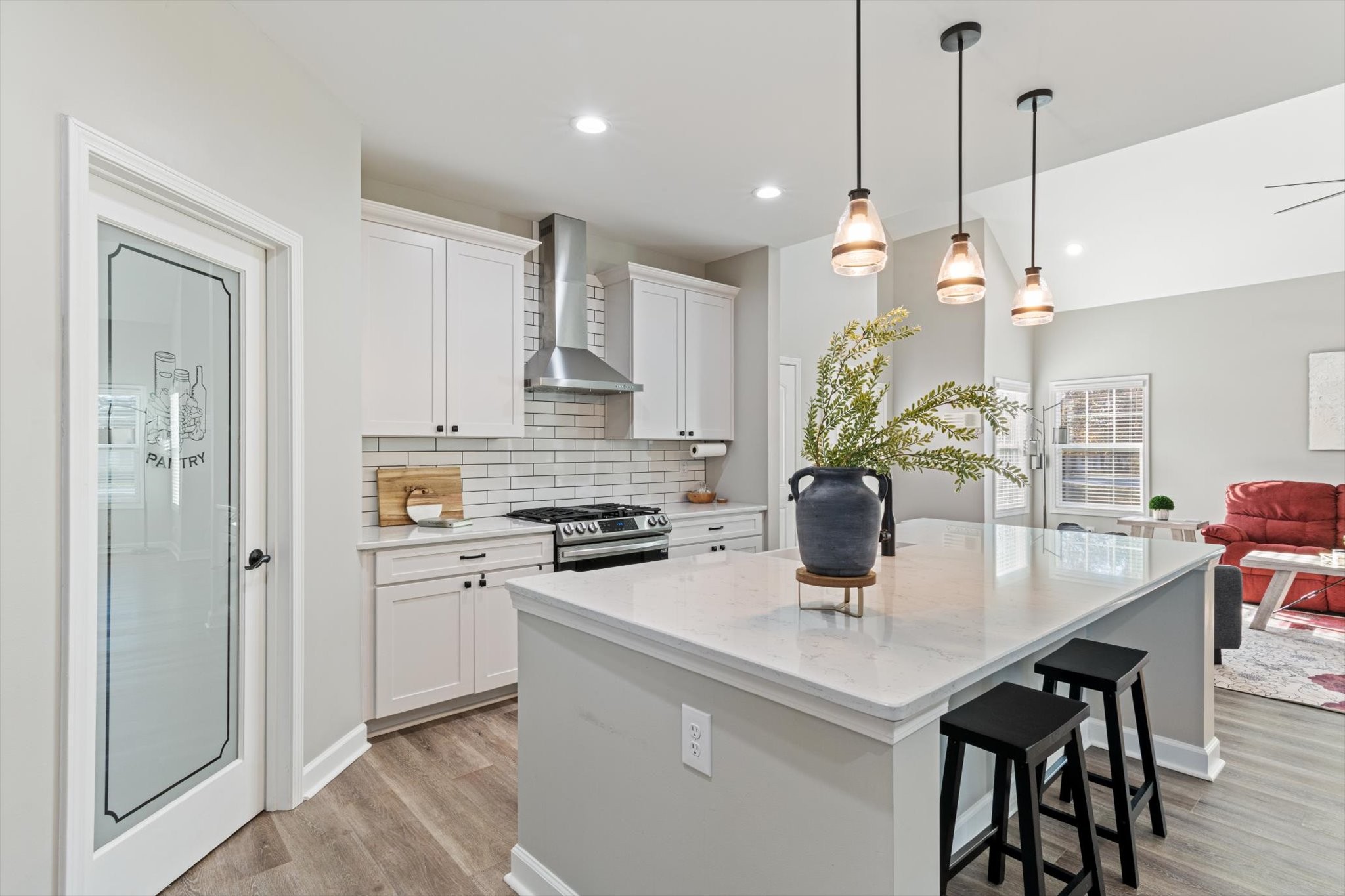 1397 Taylortown Road White Bluff, TN 37187 - Photo 11 of 26 a kitchen with stainless steel appliances granite countertop a stove a refrigerator a sink a dining table and chairs with wooden floor