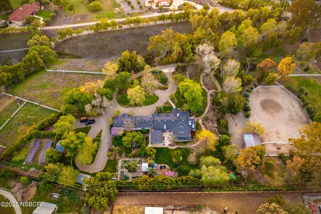 an aerial view of residential houses with outdoor space