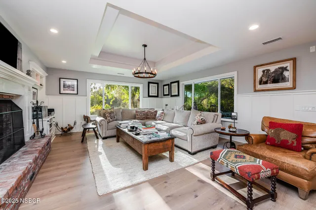 a living room with furniture and a fireplace