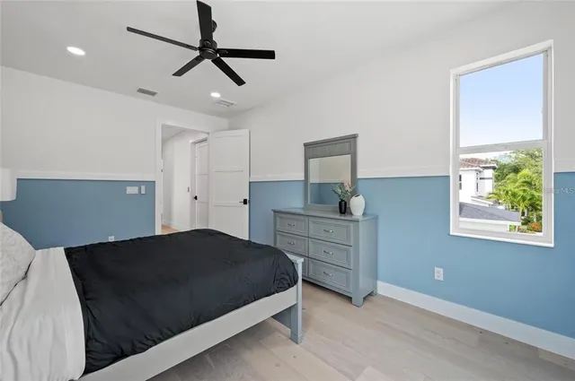 a living room with furniture and a ceiling fan