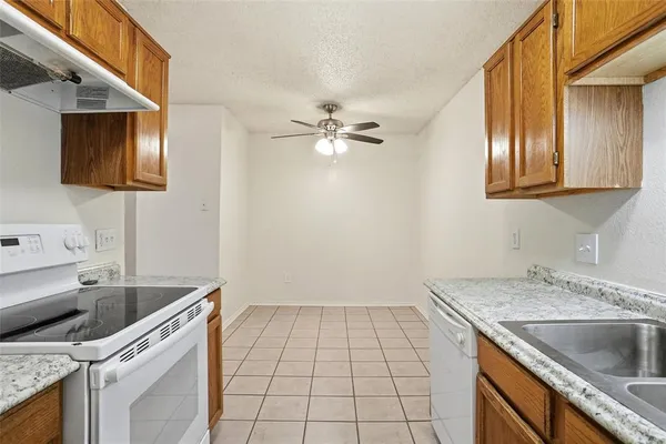 a kitchen with a sink and a stove top oven