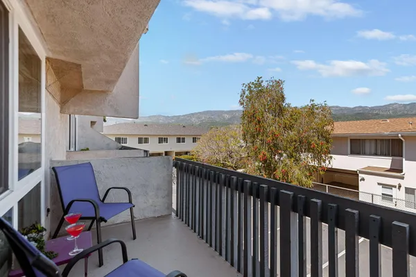 a balcony with table and chairs
