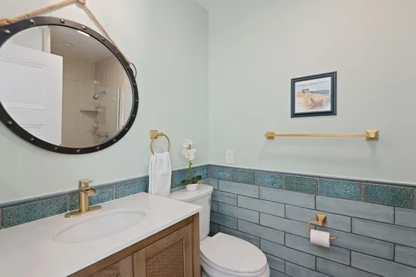 a bathroom with a sink mirror vanity and toilet