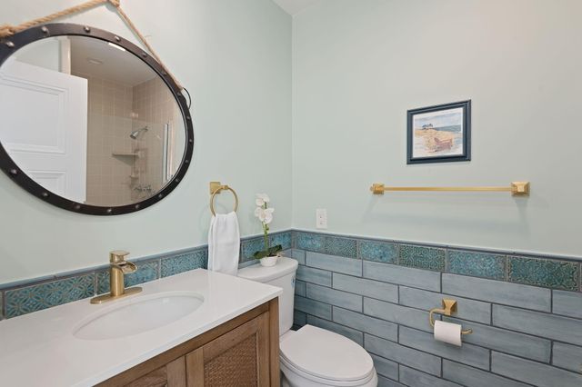 a view of a house with a barbeque and bench