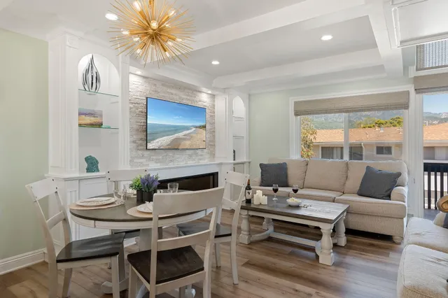 a living room with furniture a table and a fireplace