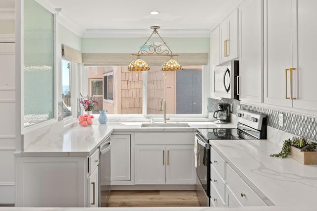 a kitchen with a sink stove and cabinets