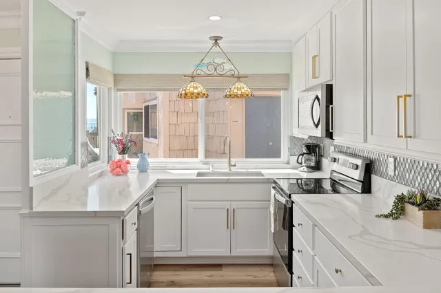 a kitchen with a sink stove and cabinets