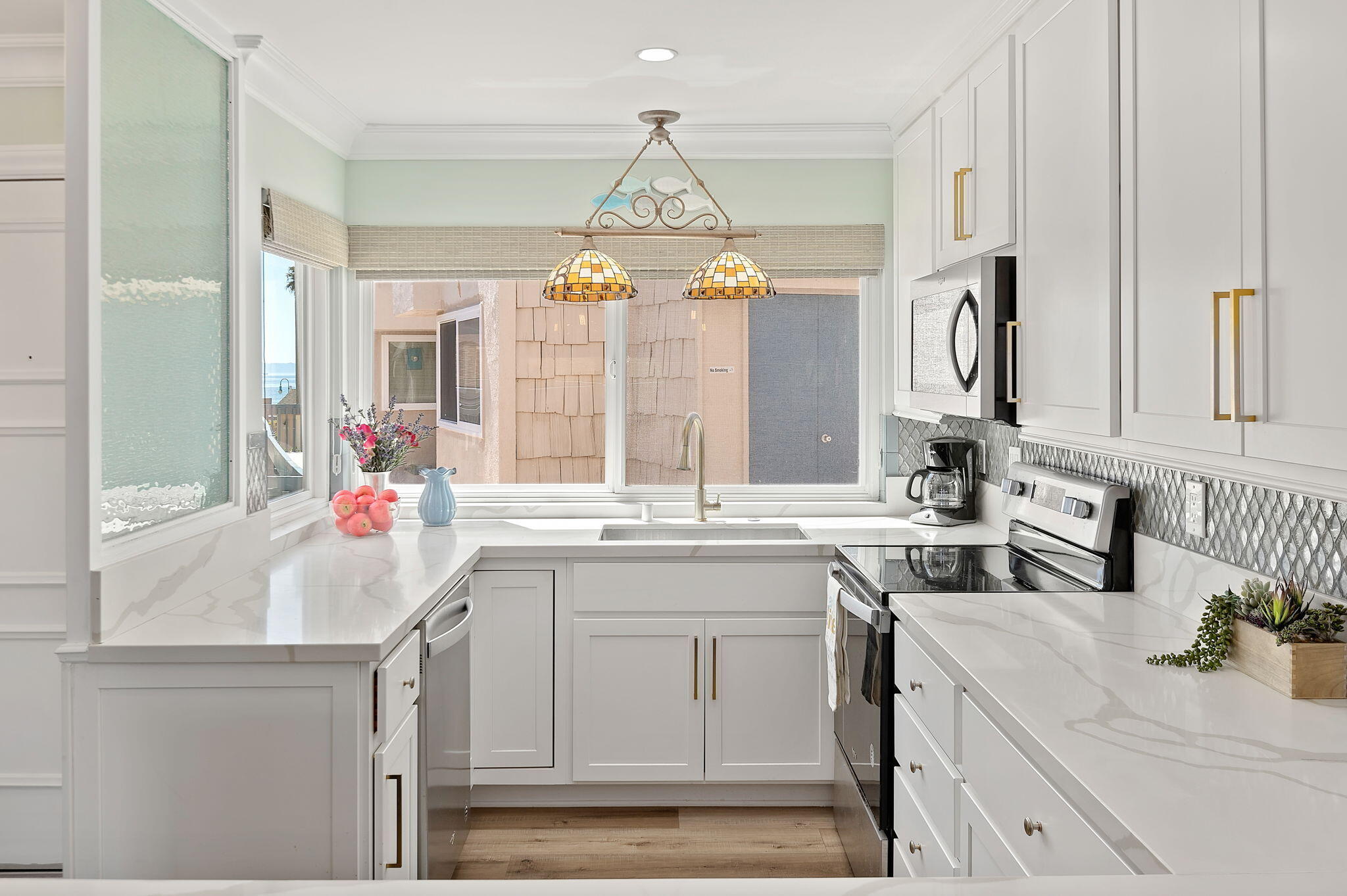 Undisclosed Address Carpinteria, CA 93013 - Photo 6 of 22 a kitchen with a sink stove and cabinets