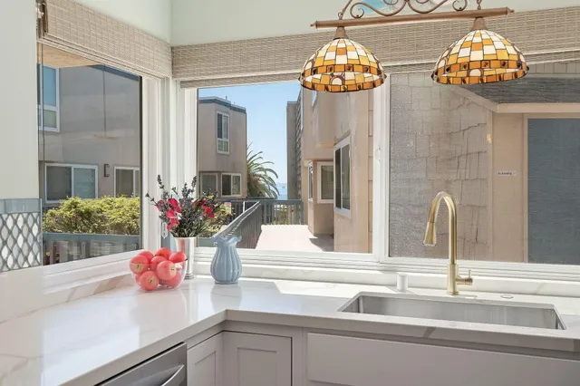 a bathroom sink with a granite countertop potted plant on top of it