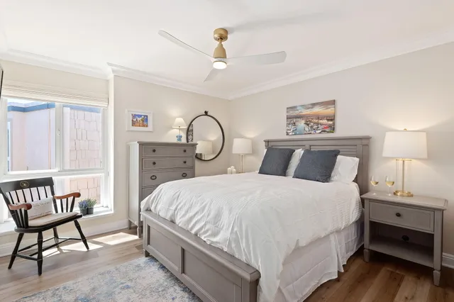 a bedroom with bed and a chandelier